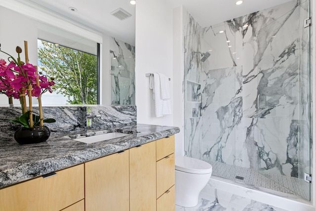 1225 Shoreline Dr, Orono, MN 55391 - full bathroom with marble look tile flooring, a marble finish shower, recessed lighting, toilet, and vanity