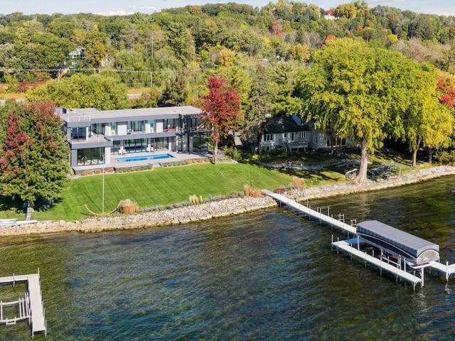 1225 Shoreline Dr, Orono, MN 55391 - dock area featuring a water view, a view of trees, a lawn, and boat lift