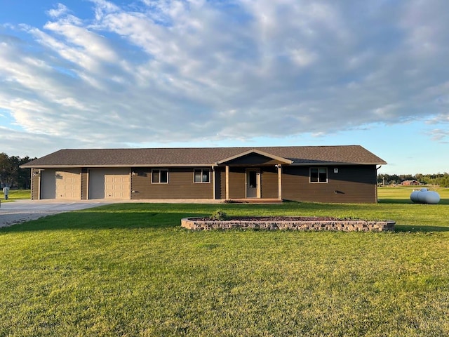 single story home featuring a garage and a front lawn