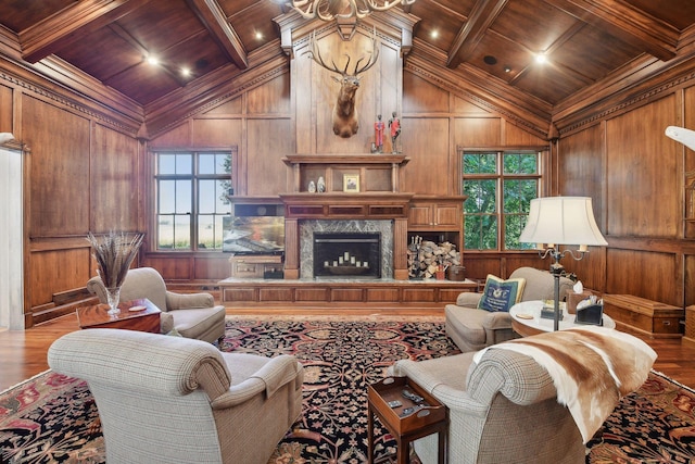 living room with wood ceiling, a healthy amount of sunlight, coffered ceiling, and beamed ceiling