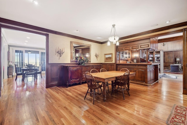 dining area featuring ornamental molding and light wood-type flooring