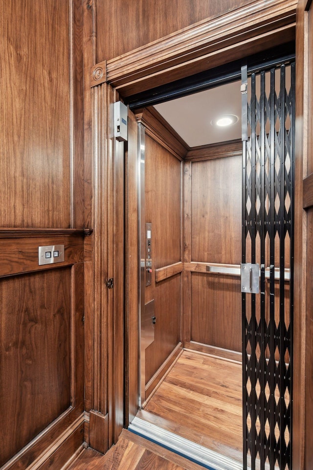 details featuring wood-type flooring and elevator