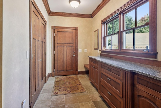 doorway featuring crown molding