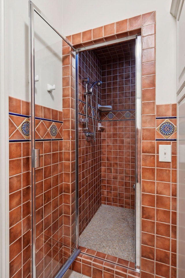 bathroom with tiled shower