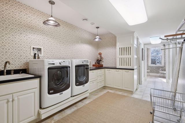 clothes washing area featuring light tile patterned flooring, cabinets, separate washer and dryer, and sink