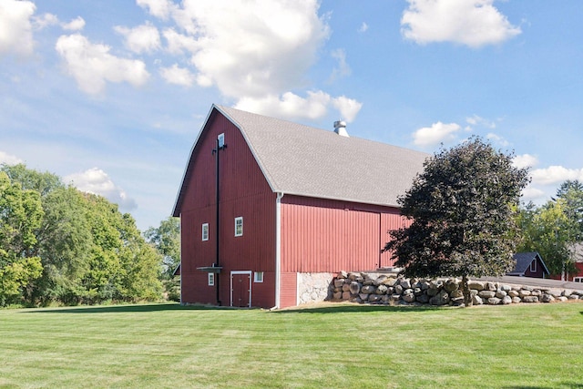 view of outbuilding with a yard