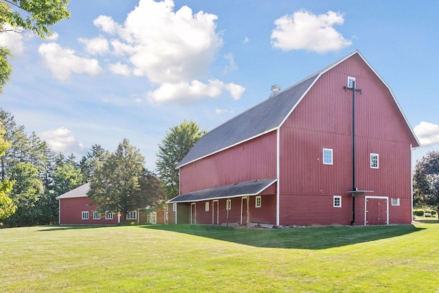 exterior space featuring an outbuilding and a lawn