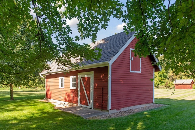 view of outbuilding featuring a yard