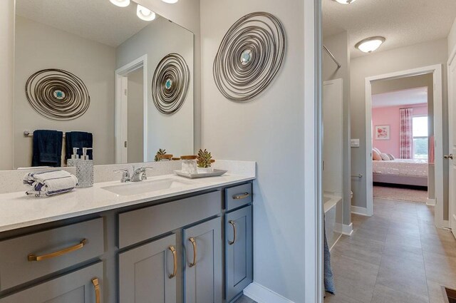 bathroom featuring vanity, a textured ceiling, and tile patterned floors