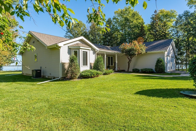 single story home with central AC and a front yard