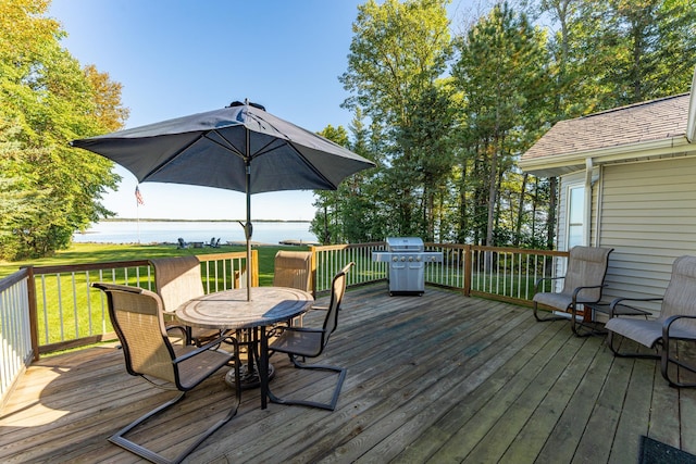 deck with a grill and a lawn