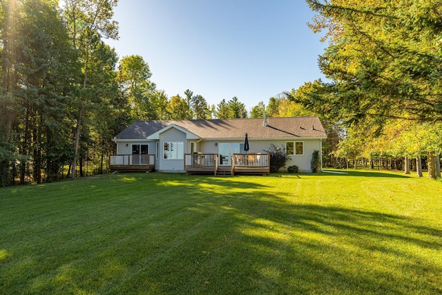 ranch-style home with a deck and a front lawn