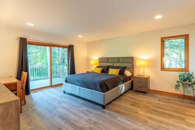 bedroom with light hardwood / wood-style flooring, multiple windows, and access to outside