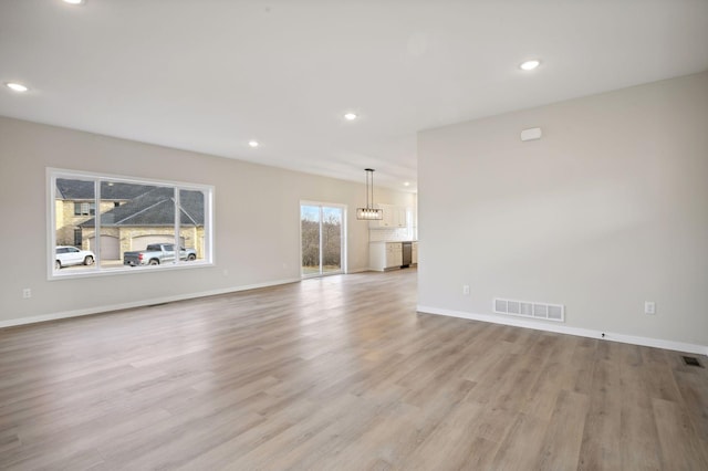 unfurnished living room with light wood-type flooring