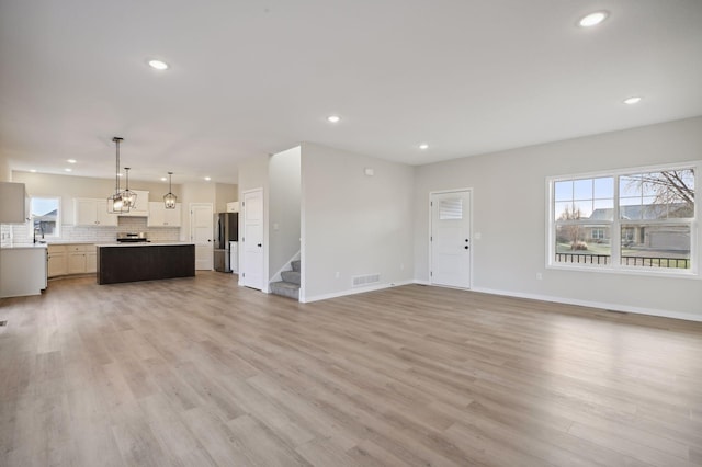 unfurnished living room with light hardwood / wood-style floors