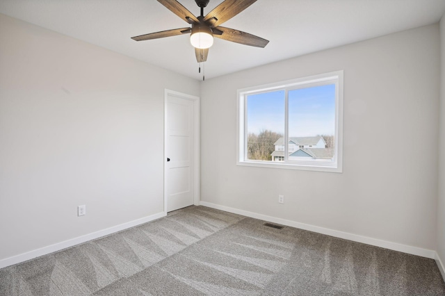 spare room featuring ceiling fan and carpet