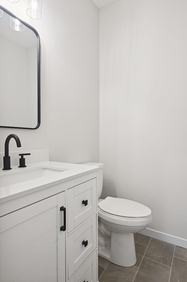 bathroom with vanity, toilet, and tile patterned floors