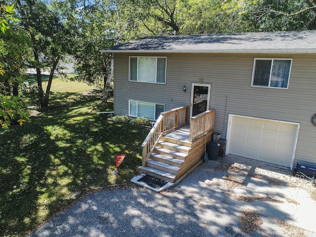 bi-level home featuring a garage and a front yard