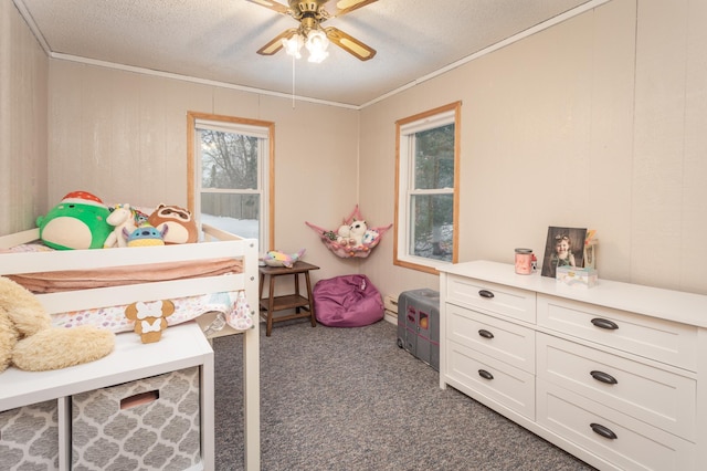 carpeted bedroom featuring ornamental molding, ceiling fan, and a textured ceiling