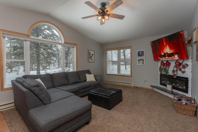 11421 Abby Ln NW, Alexandria, MN 56308 - living room featuring vaulted ceiling, a ceiling fan, a fireplace, a baseboard heating unit, and baseboards