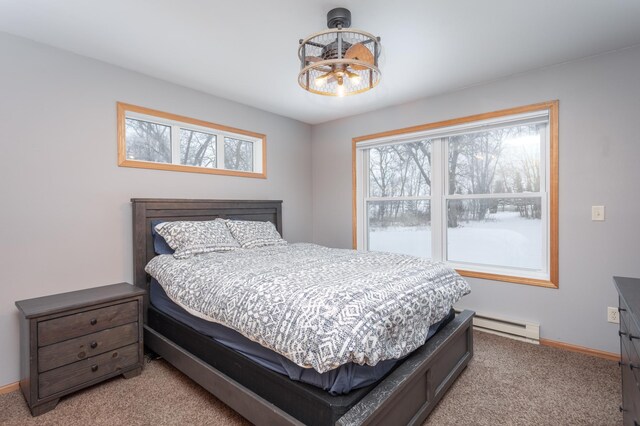 11421 Abby Ln NW, Alexandria, MN 56308 - bedroom with a chandelier, a baseboard radiator, light carpet, and baseboards