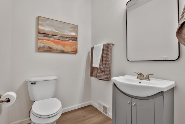 bathroom featuring hardwood / wood-style floors, vanity, and toilet