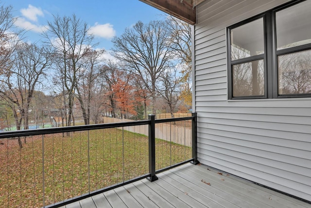 wooden terrace featuring a yard