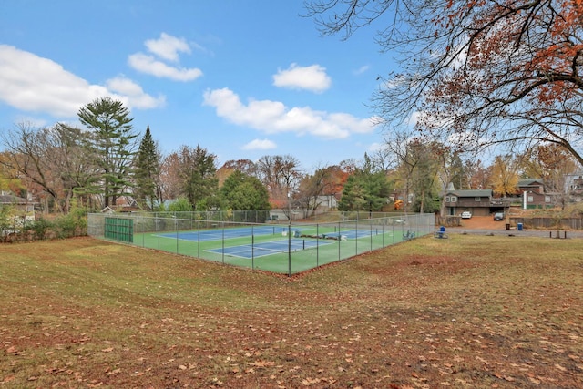 view of tennis court featuring a lawn