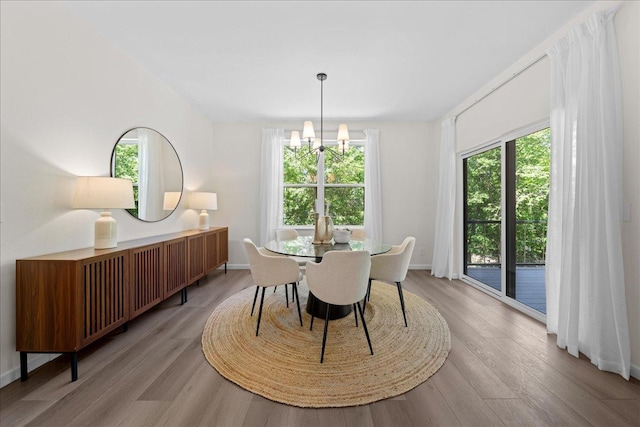 3828 Northern Ave, Spring Park, MN 55384 - dining area with healthy amount of natural light, a chandelier, light wood-style flooring, and baseboards