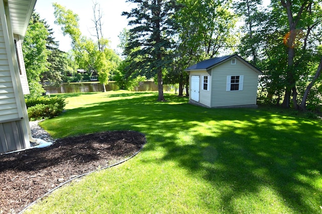 view of yard featuring a water view and a shed