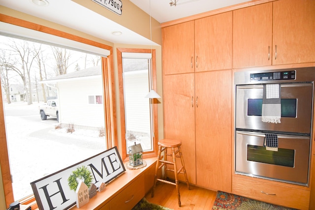 kitchen with hardwood / wood-style floors and double oven