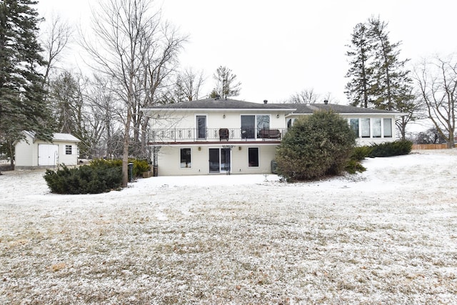 snow covered property featuring a shed and a deck