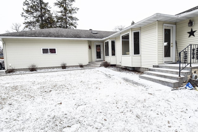 view of snow covered back of property