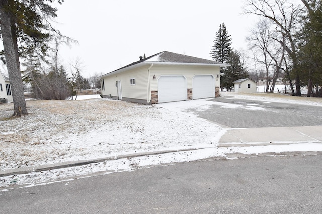 view of side of home with an outdoor structure and a garage