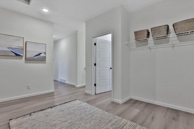 interior space with recessed lighting, wood finished floors, visible vents, and baseboards