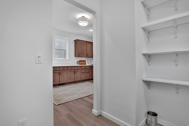 washroom featuring baseboards and light wood-style floors