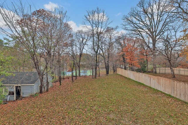 view of yard featuring fence and an outdoor structure