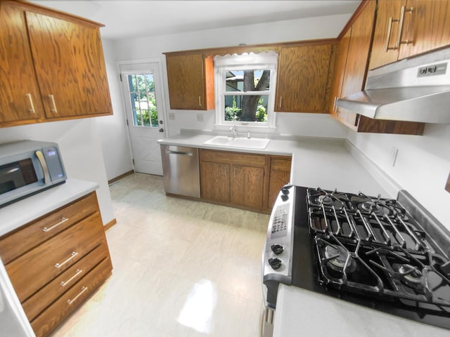 kitchen with gas range, sink, and stainless steel dishwasher