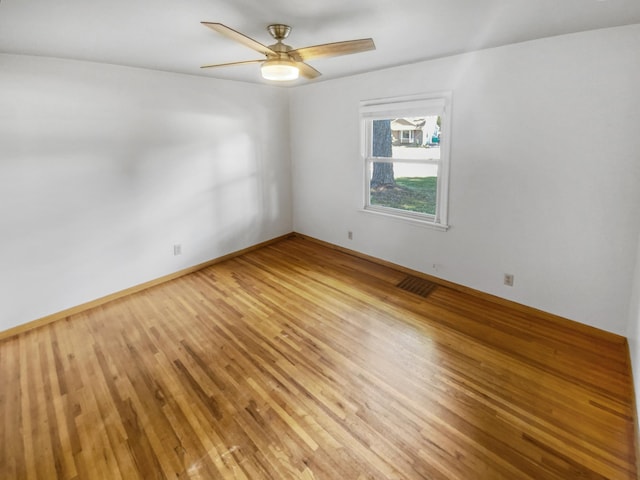 spare room with light hardwood / wood-style floors and ceiling fan