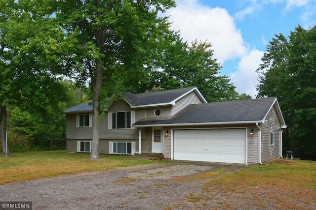 view of front facade with a garage and a front lawn