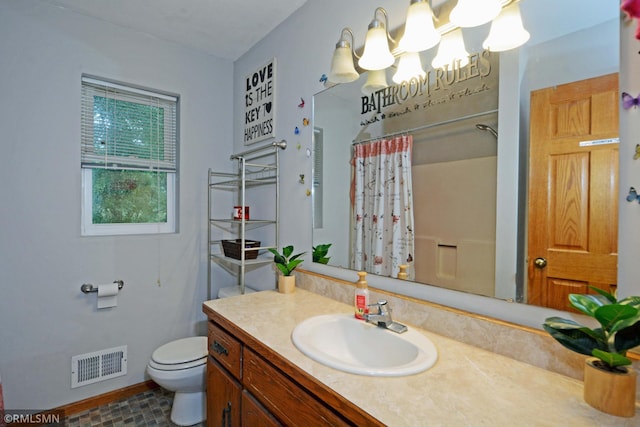 bathroom with walk in shower, vanity, and toilet