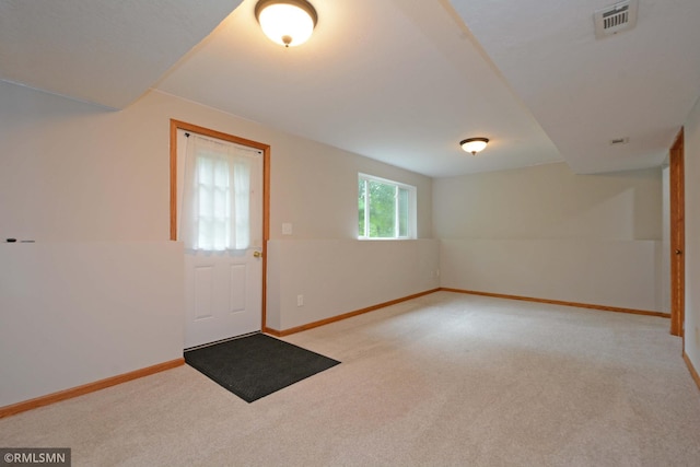 entryway with light colored carpet