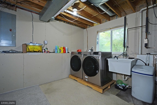 clothes washing area with electric panel, independent washer and dryer, and sink