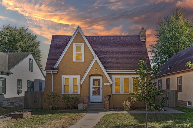 tudor house featuring a lawn