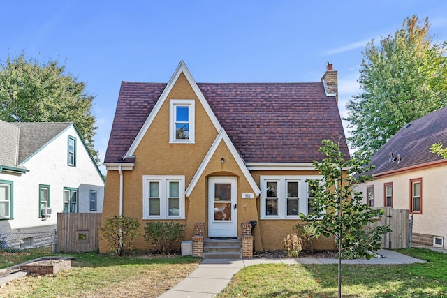 tudor house featuring a front lawn