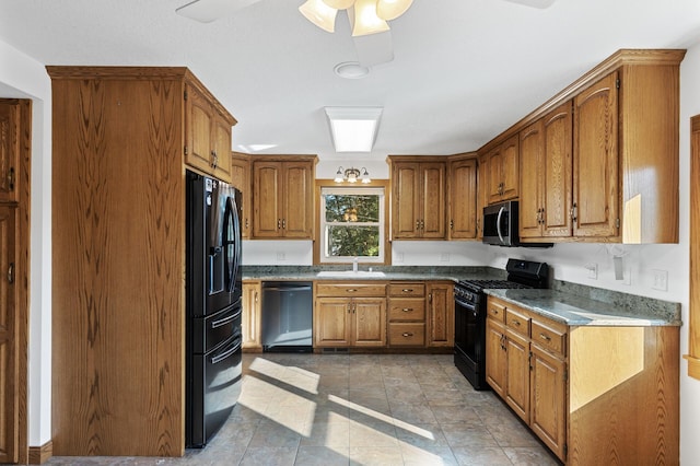 kitchen featuring light tile patterned floors, black appliances, sink, and ceiling fan