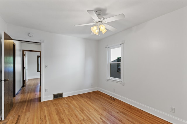 unfurnished room with ceiling fan and wood-type flooring