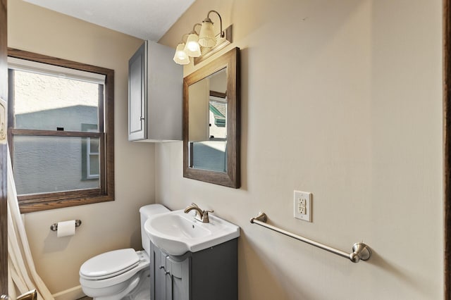 bathroom featuring vanity and toilet