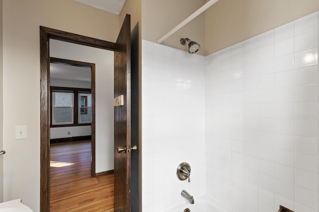 bathroom featuring bathtub / shower combination and wood-type flooring