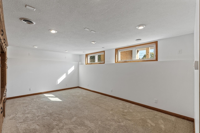 basement with a textured ceiling and carpet flooring